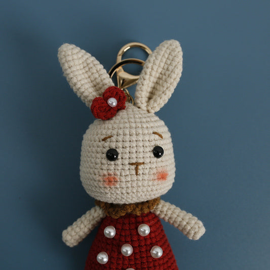 Close-up face detail of handmade crochet bunny plush keychain