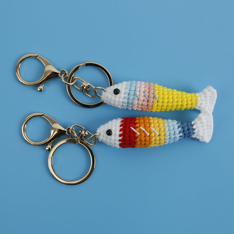 Close-up of crochet fish plush keychain showing metal keyring attachment