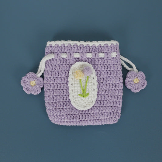 Tulip design crochet pouch on a flat surface