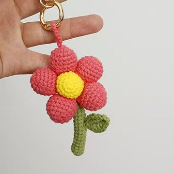 Pink crochet flower keychain with adorable handmade details, perfect as a bag charm, keychain, or thoughtful handmade gift.