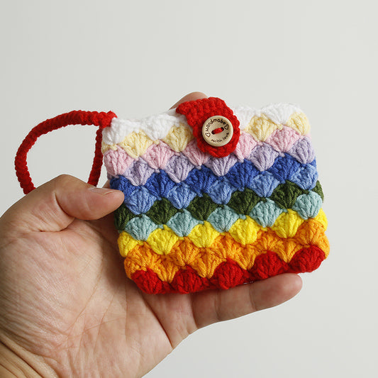 Hand holding Rainbow Crochet Card Cover showing size and colorful design