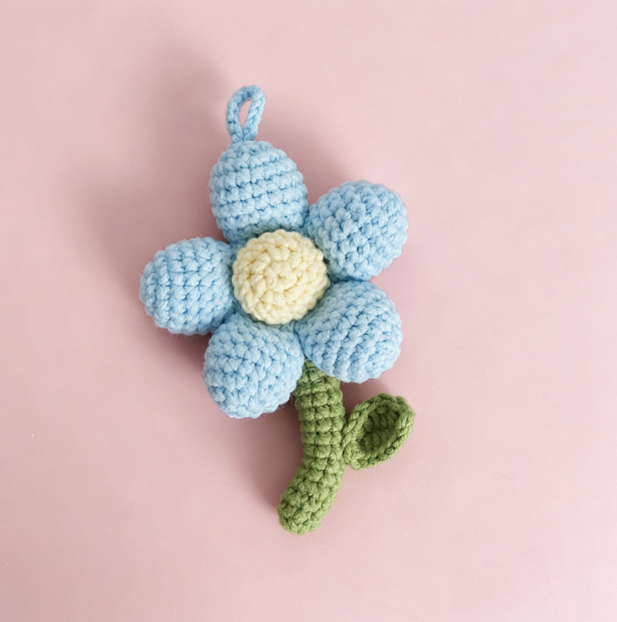 Blue crochet flower keychain handmade from soft yarn, cute floral accessory for keys, bags, and backpacks