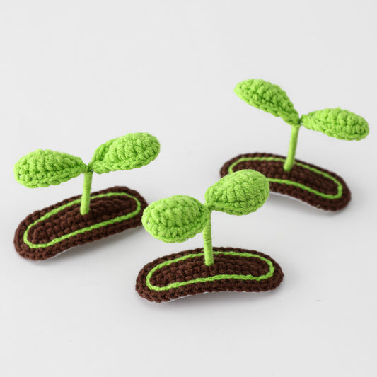 Close-up of crochet bud hairclip showing stitching and texture details