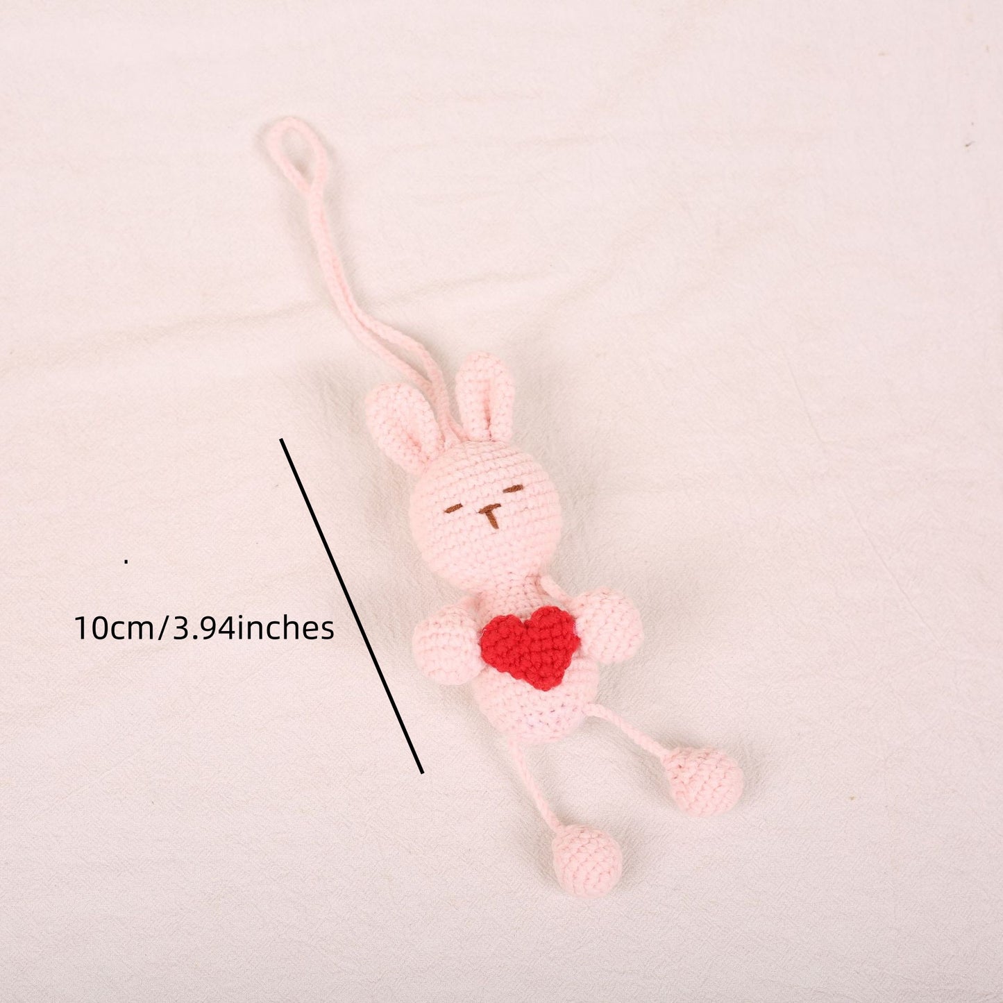 Cute crochet bunny plush keychain with dangling legs created from beginner crochet kit