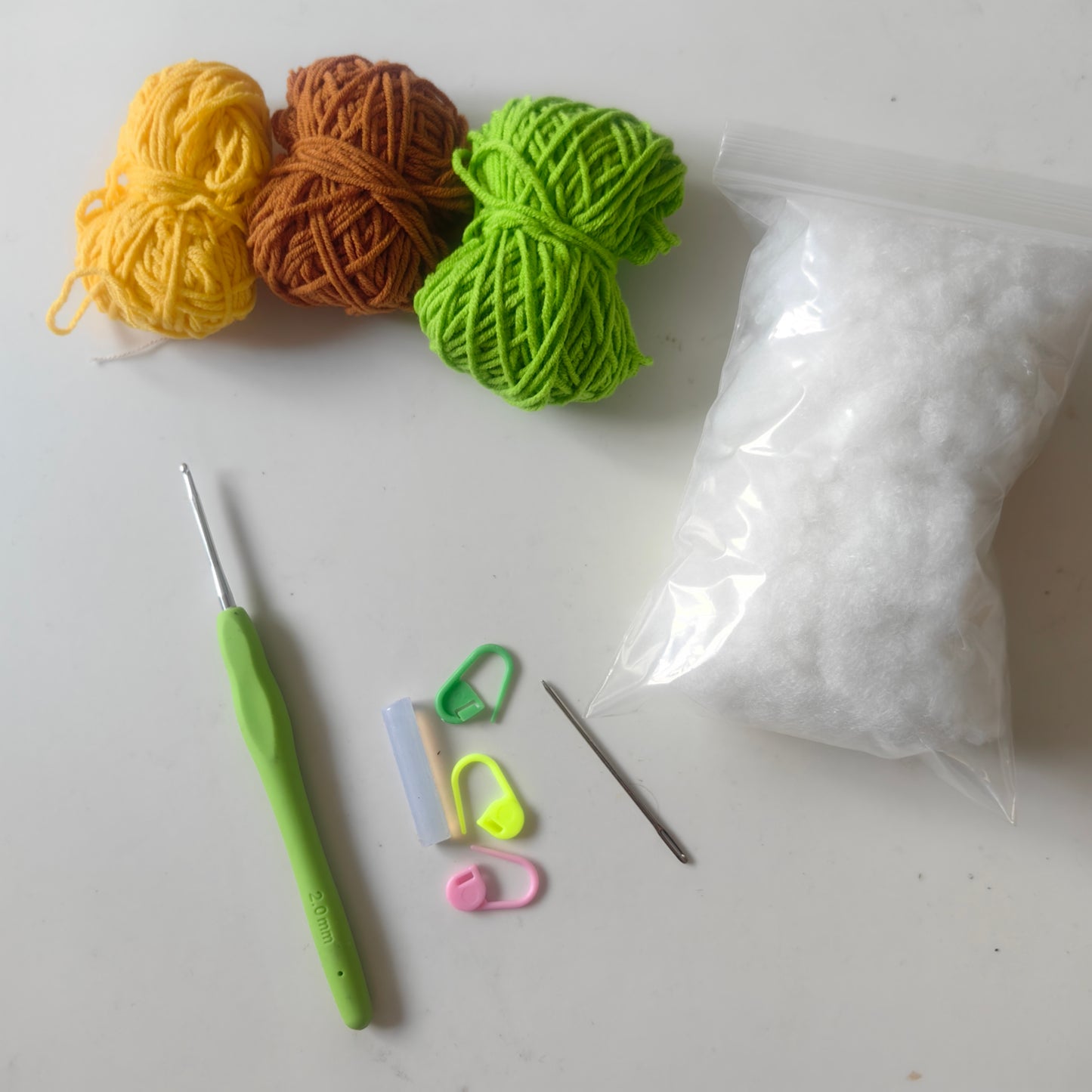 Complete crochet cactus keychain kit with yarn, stuffing, crochet hook, accessories and materials