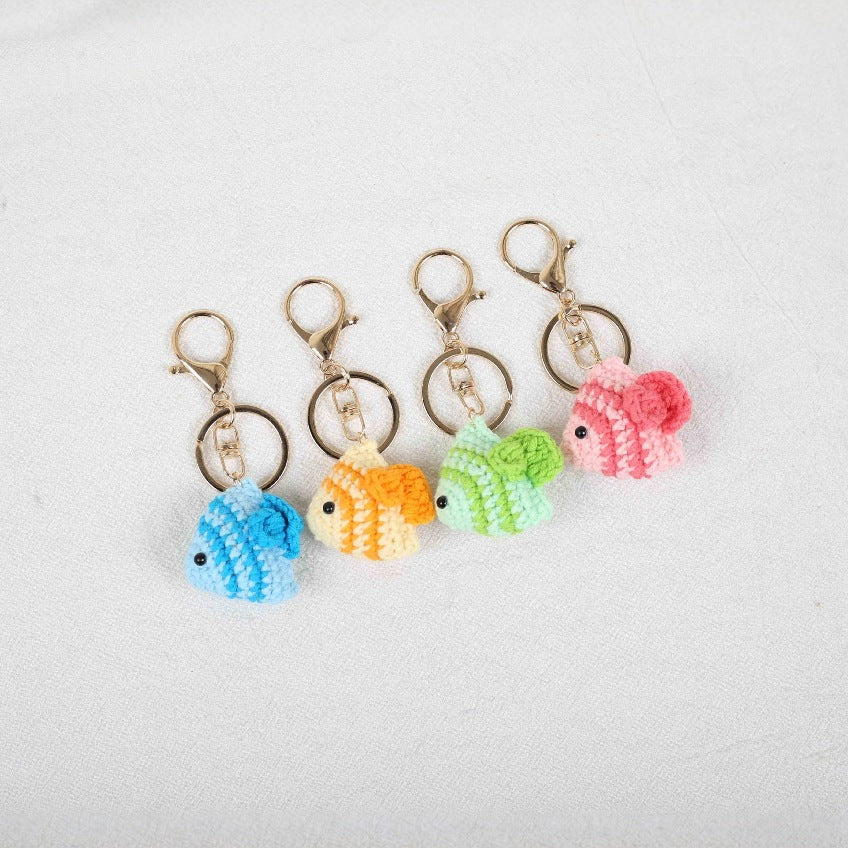 Crochet Fish Kit with four colorful fish designs in blue, yellow, pink, and green displayed