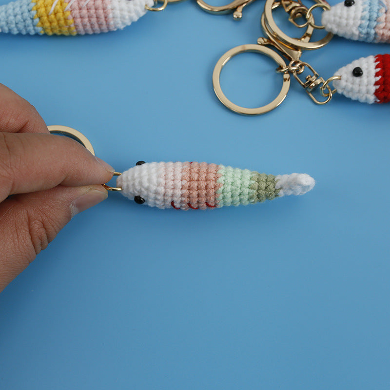 Detail view of handmade crochet fish plush keychain texture