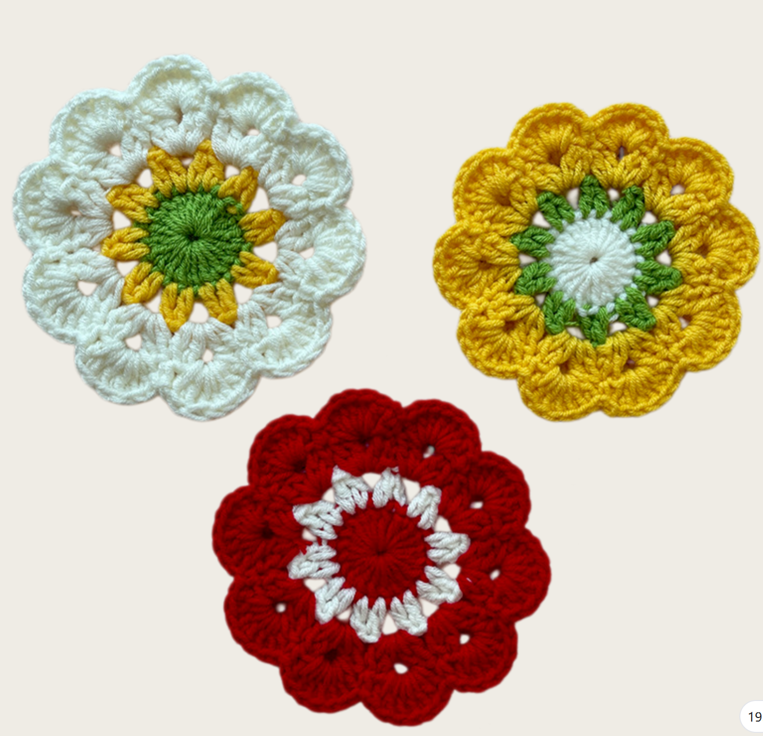 Crochet flower coaster collection in five colors displayed together as decorative handmade table accessories