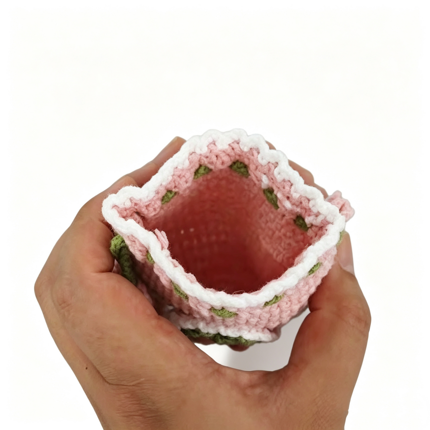 Inside view of crochet fruit drawstring pouch showing storage for cards, keys, earphones, and small daily essentials