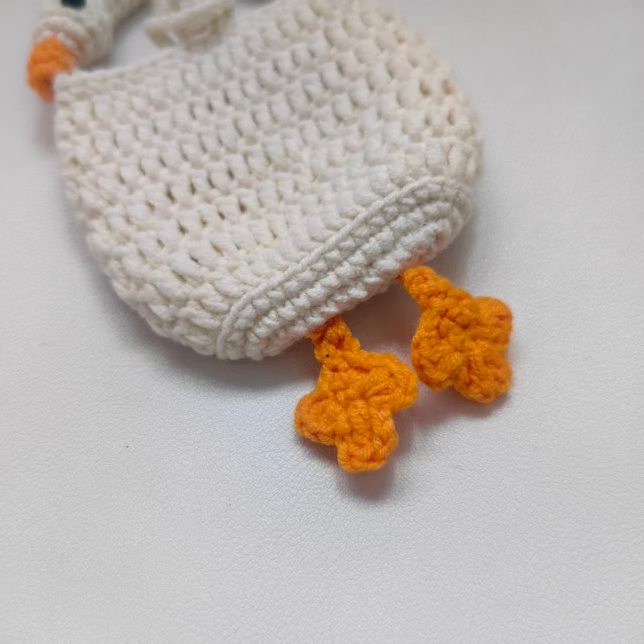 Close-up details of the crochet goose earphone case