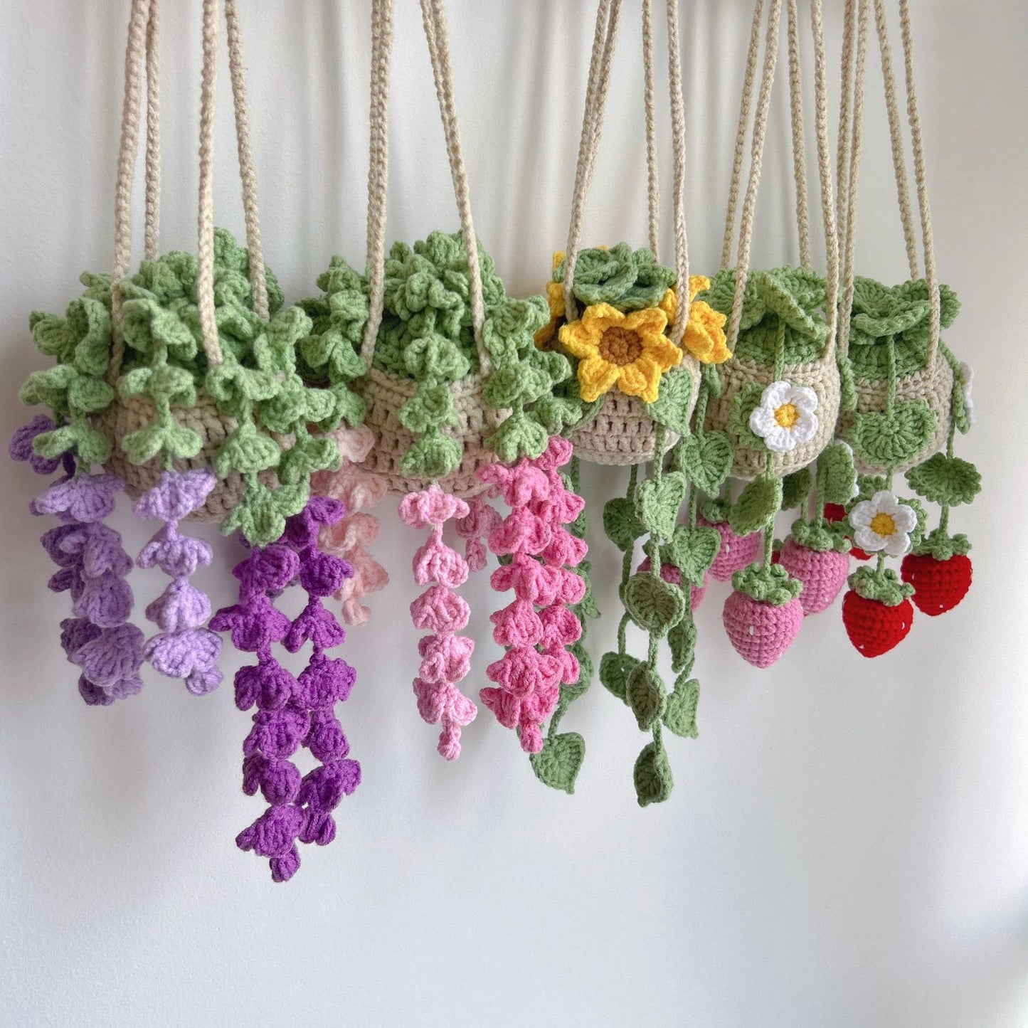 Five handmade crochet hanging basket decors displayed hanging together
