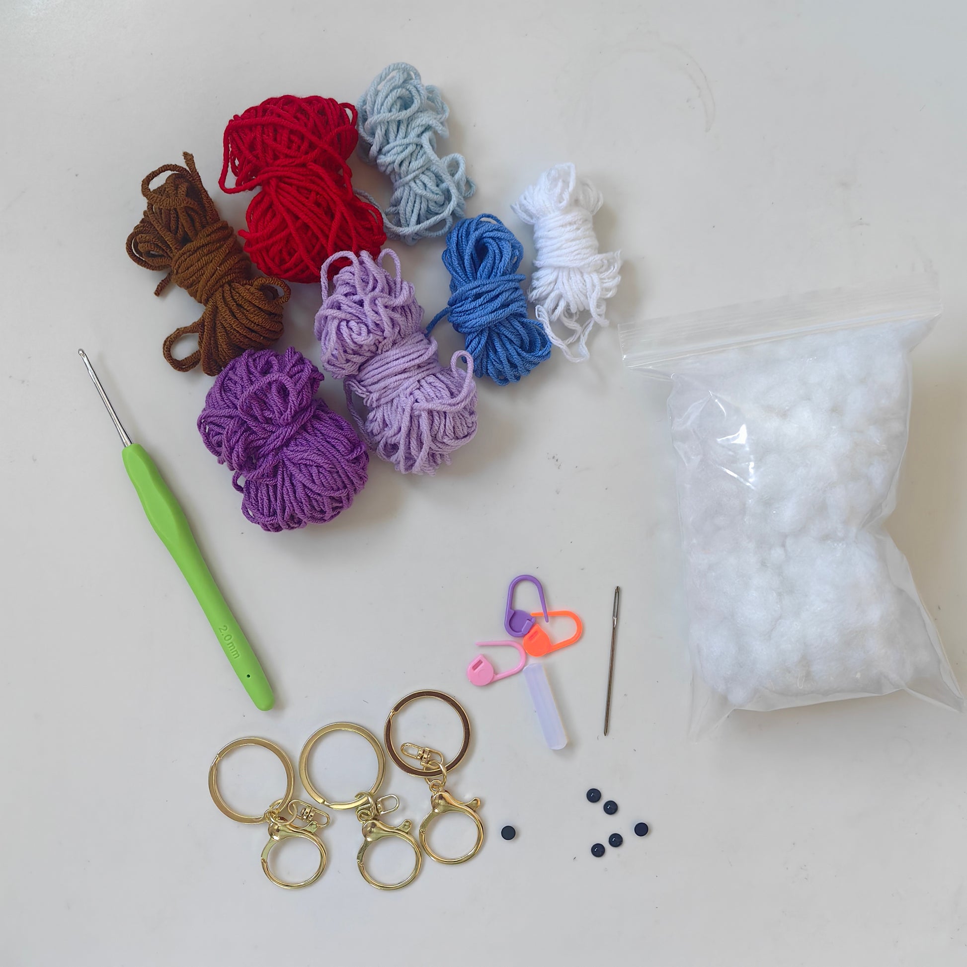 Complete Crochet Heart Plush Kit with yarn, crochet hook, stuffing, accessories, and crafting materials