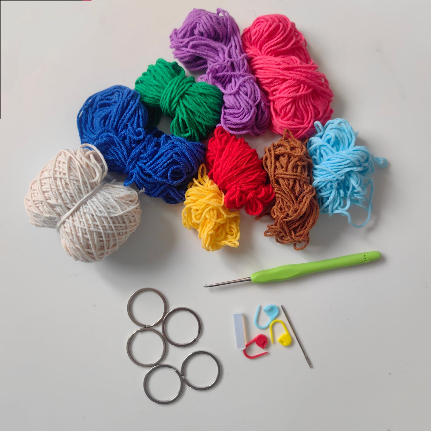Complete crochet house key cover kit materials including yarn, crochet hook, accessories, stuffing, and instructions