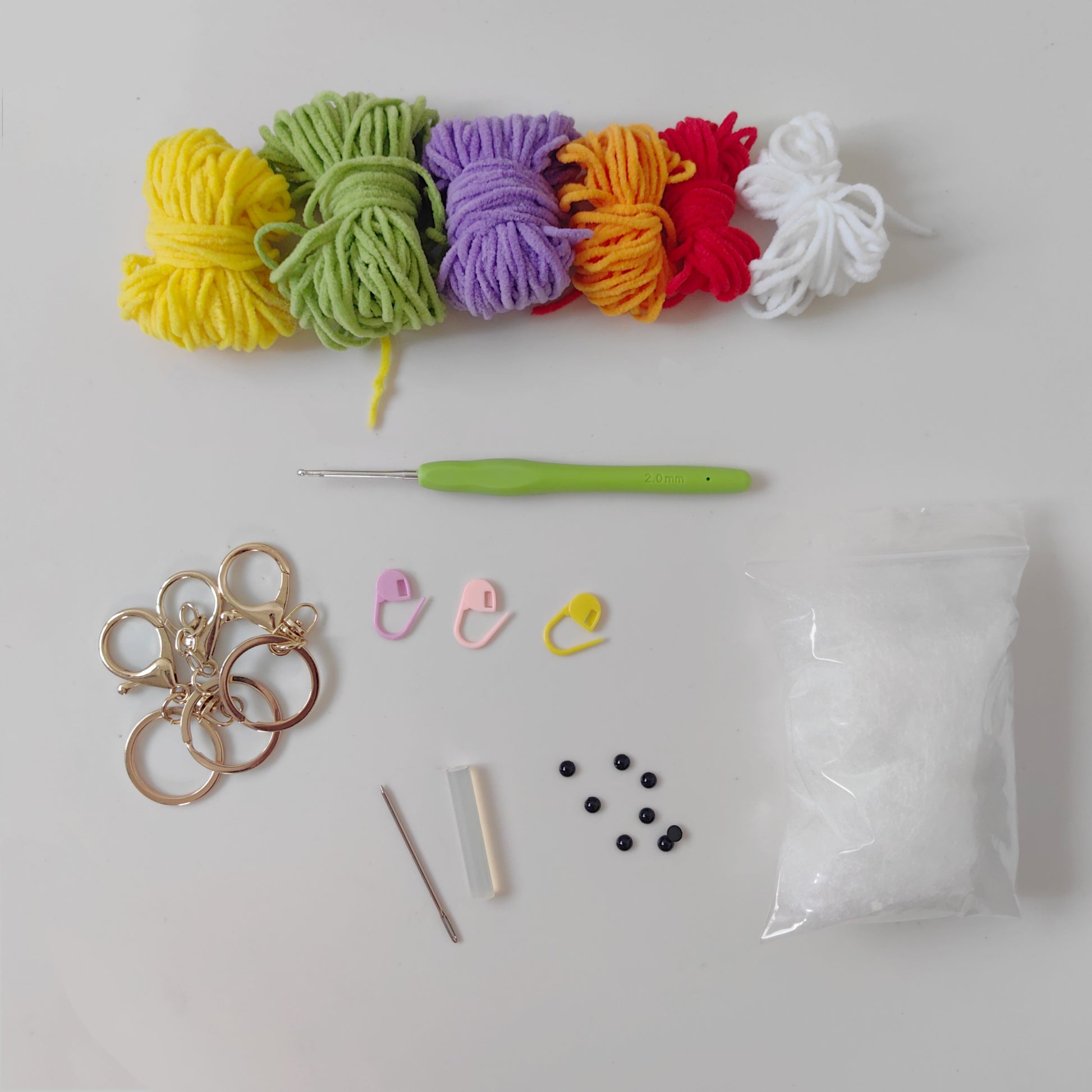 Crochet DIY kit materials including yarn hook stuffing safety eyes and tools