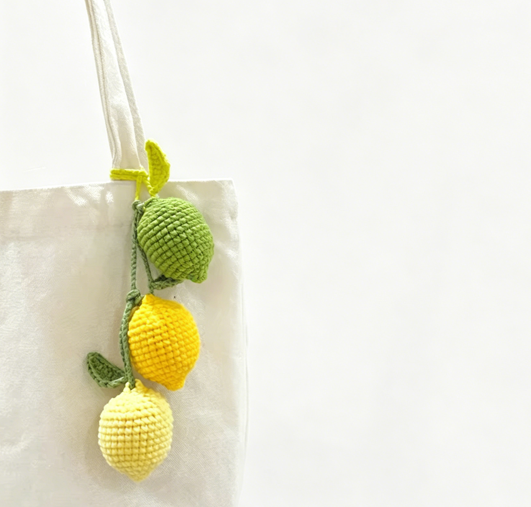Close-up of three crochet lemon plushies in different colors