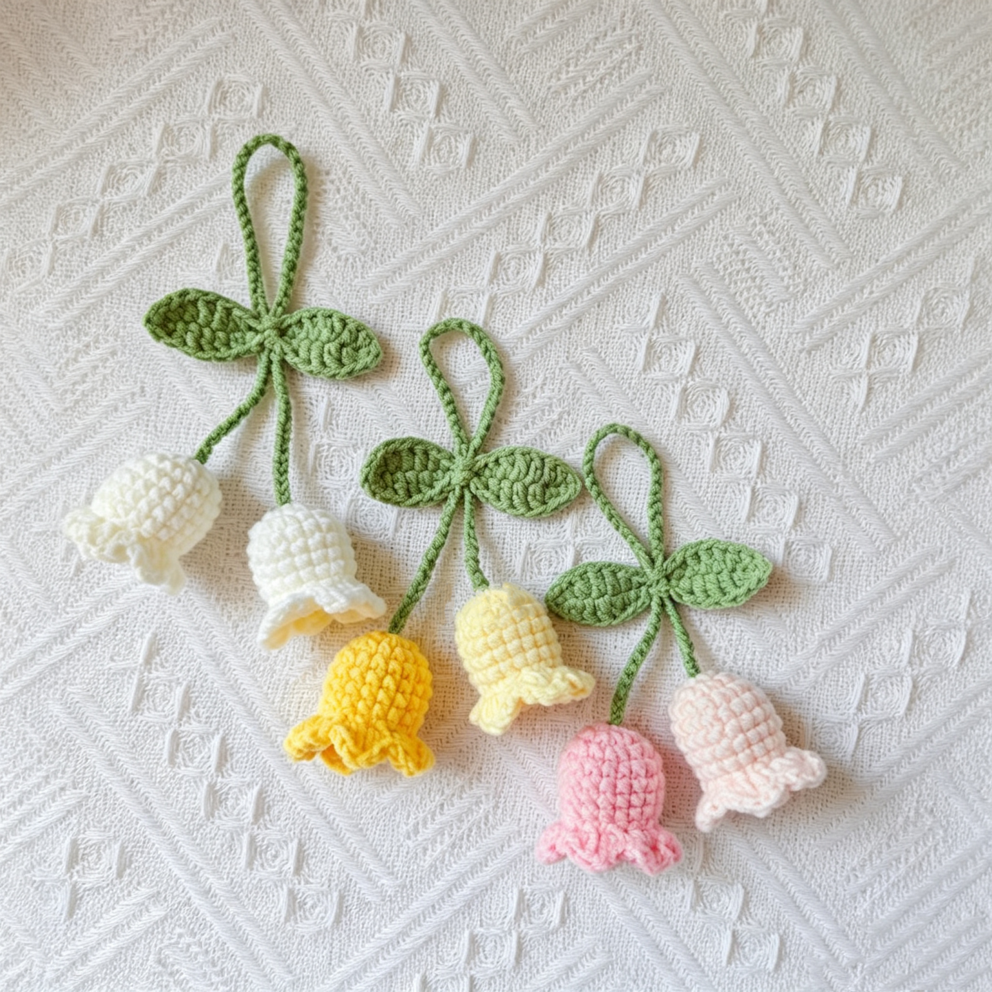 Close-up detail of cute handmade crochet Lily of the Valley flowers