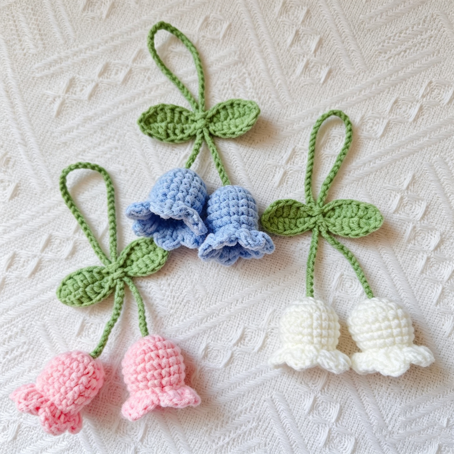 Crochet Lily of the Valley flower charm used as a keychain accessory