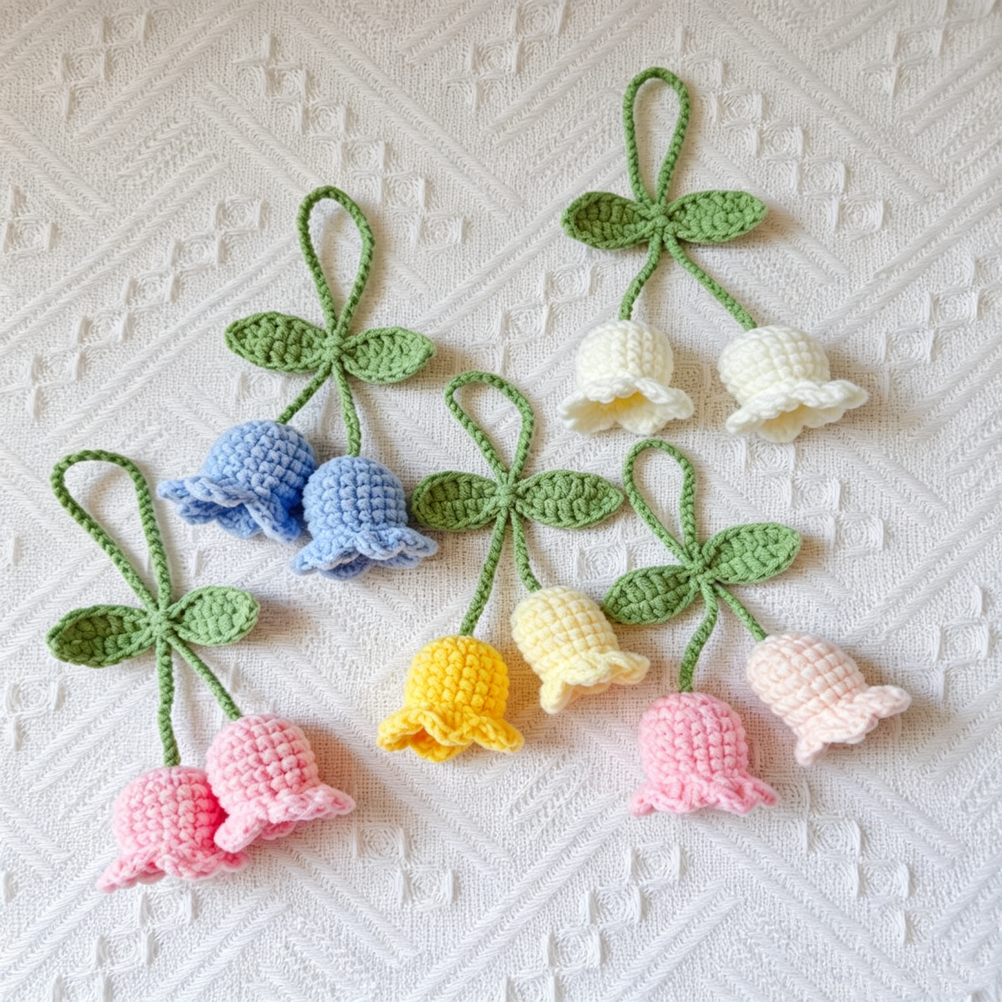Five colorful crochet Lily of the Valley flower keychains together