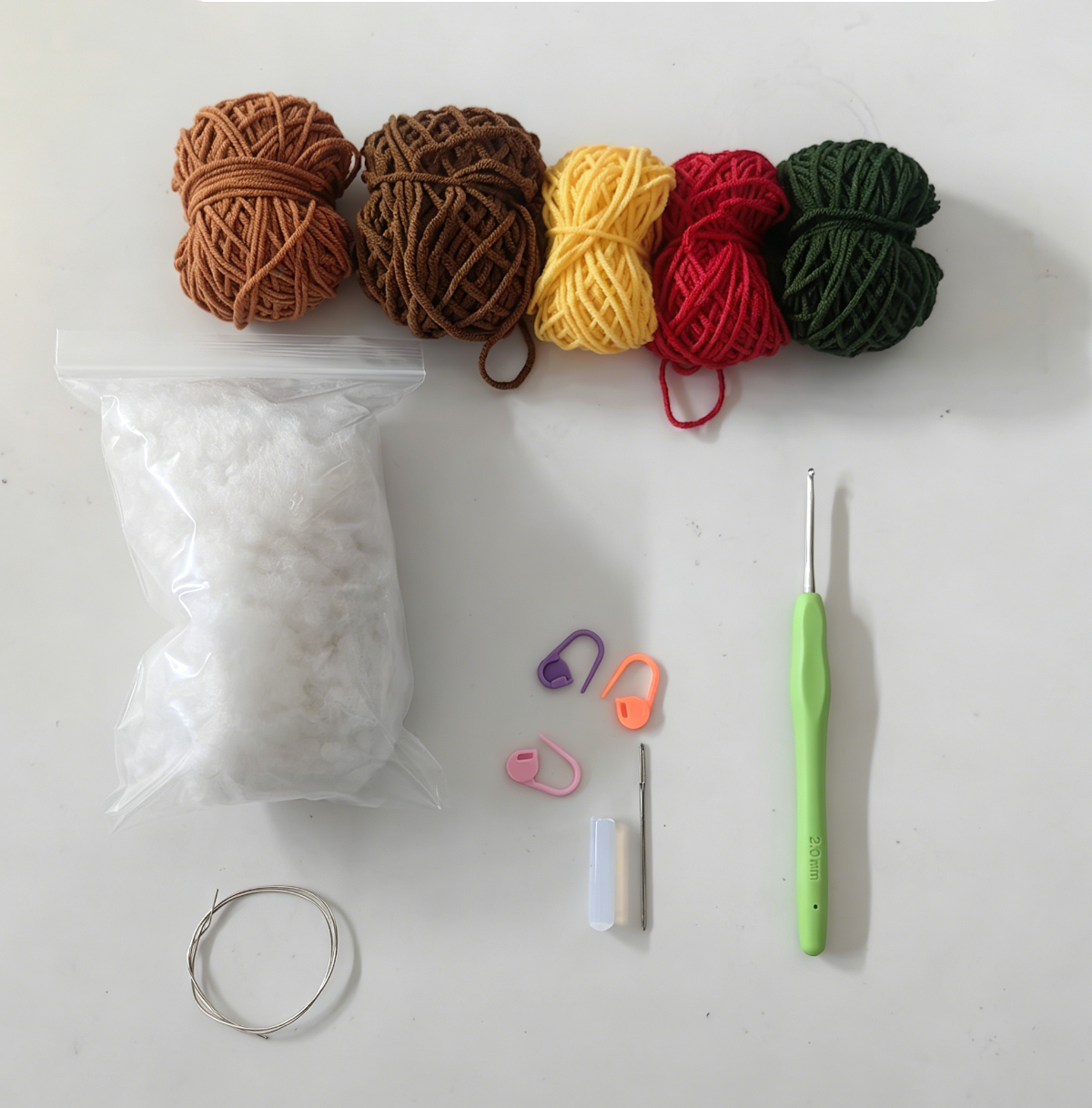 Complete Crochet Mini Flower Kit materials including yarn, crochet hook, stuffing, accessories, and tools.