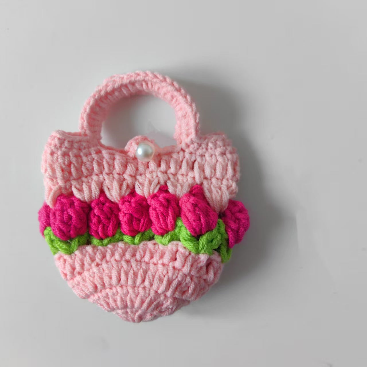 Close-up detail of handmade crochet tulip pouch