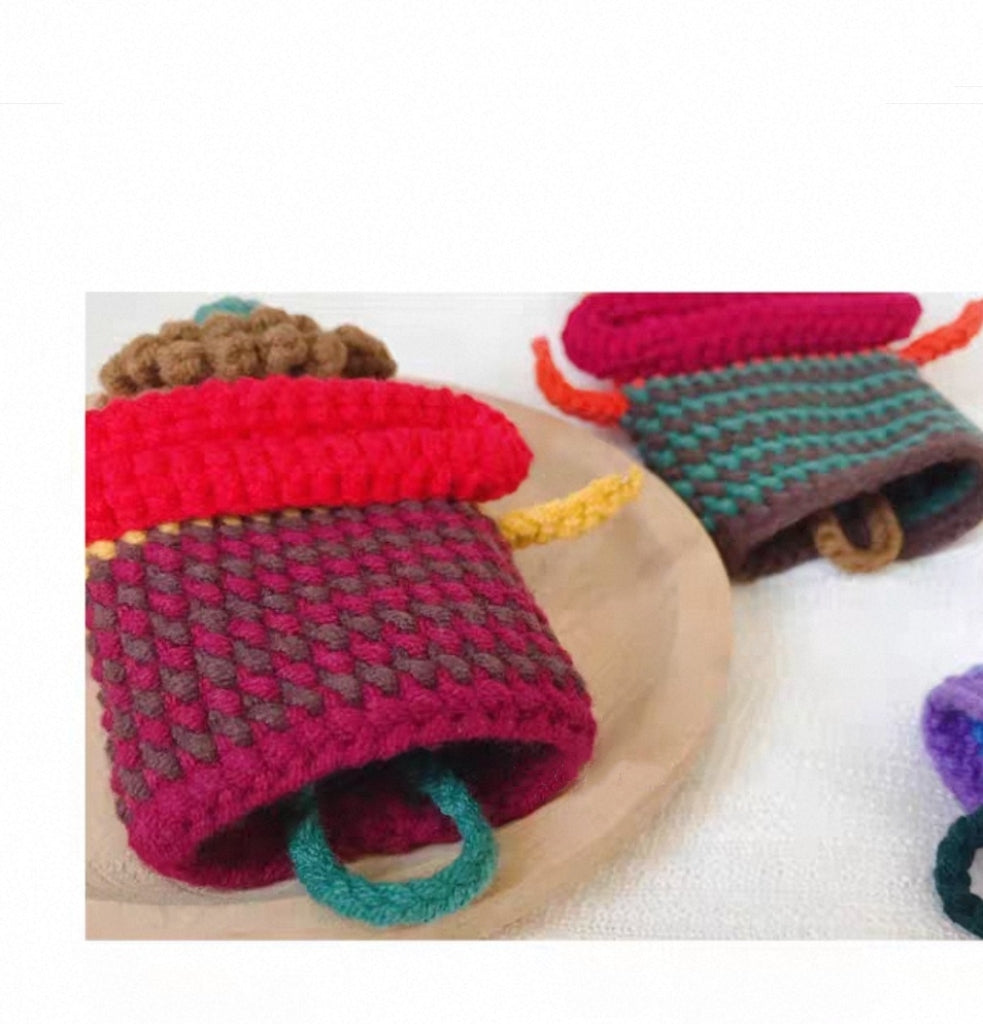 Bottom detail of crochet monster key cover showing key pouch structure and craftsmanship