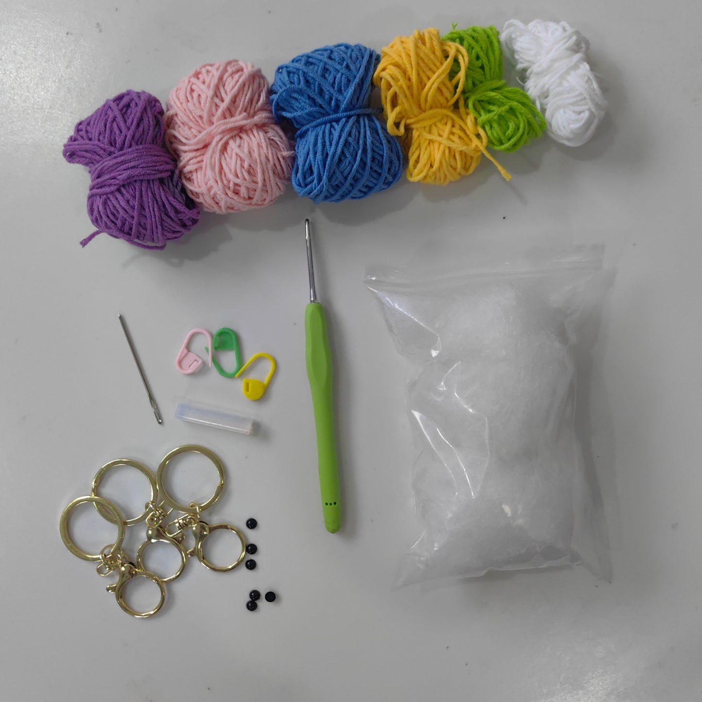 Complete Crochet Monster Keychain Kit with yarn, crochet hook, stuffing and accessories
