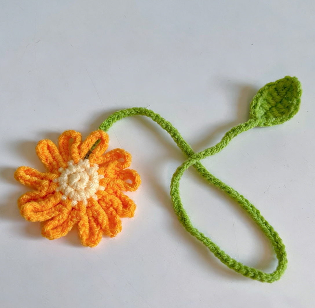 Orange crochet flower bookmark handmade with soft yarn and decorative floral design