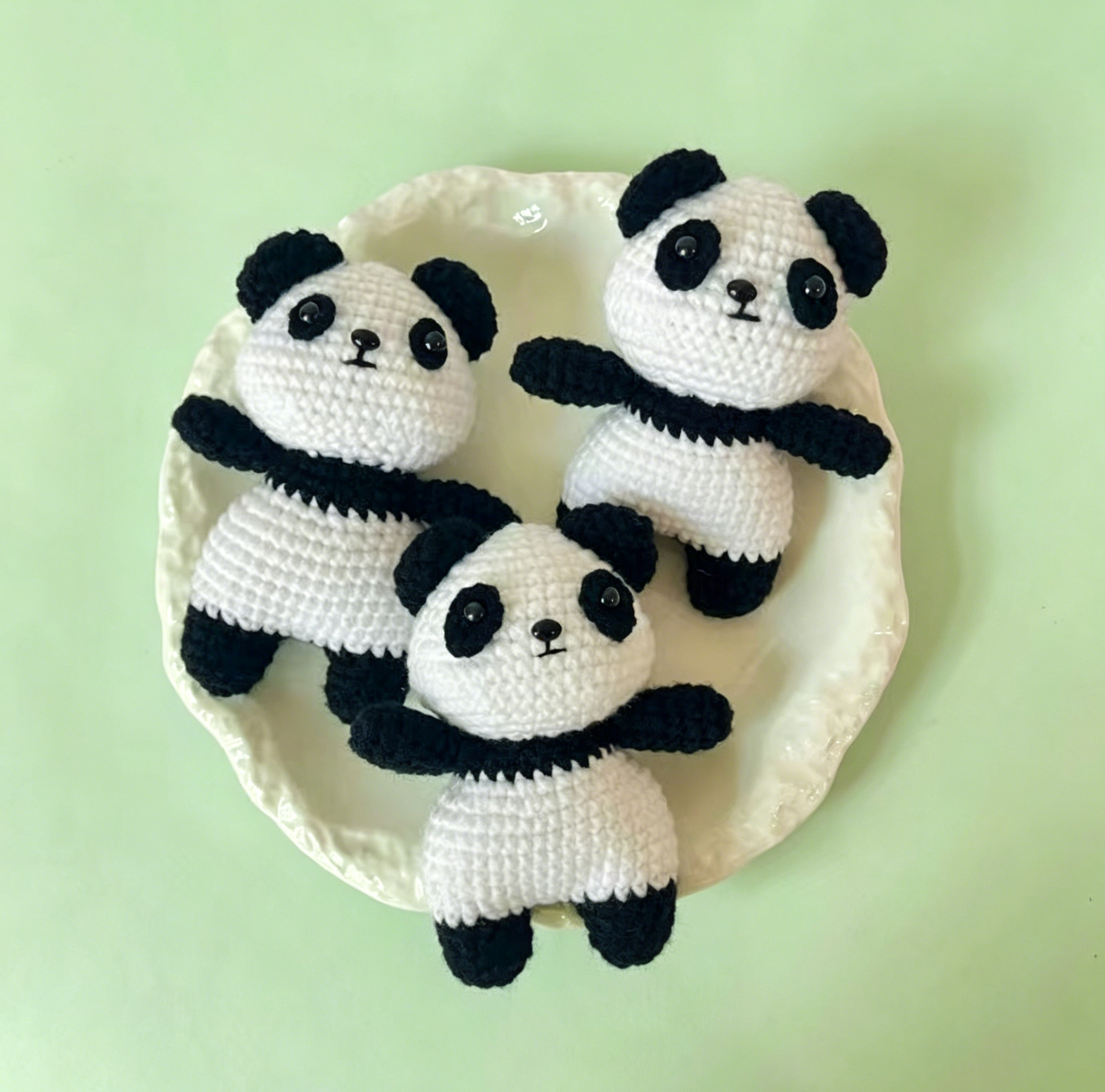Three adorable crochet panda plush keychains displayed together, cute handmade amigurumi panda crochet kit from Little Loop Crochet