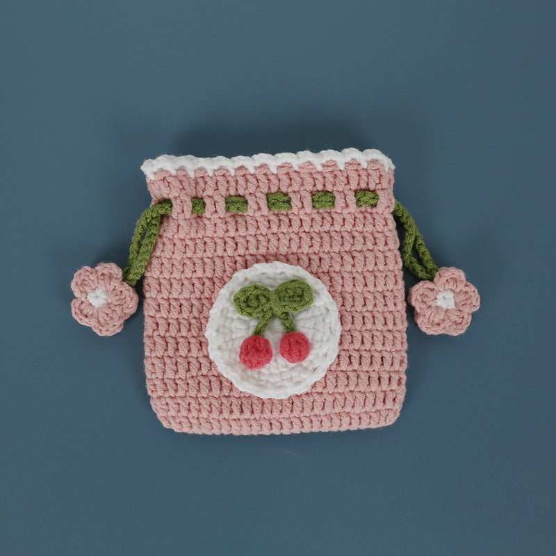 Cherry design crochet pouch on a flat surface