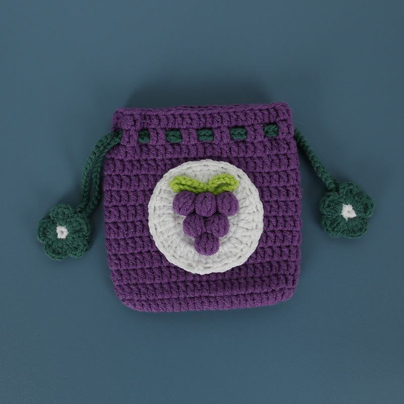 Grape design crochet pouch on a flat surface