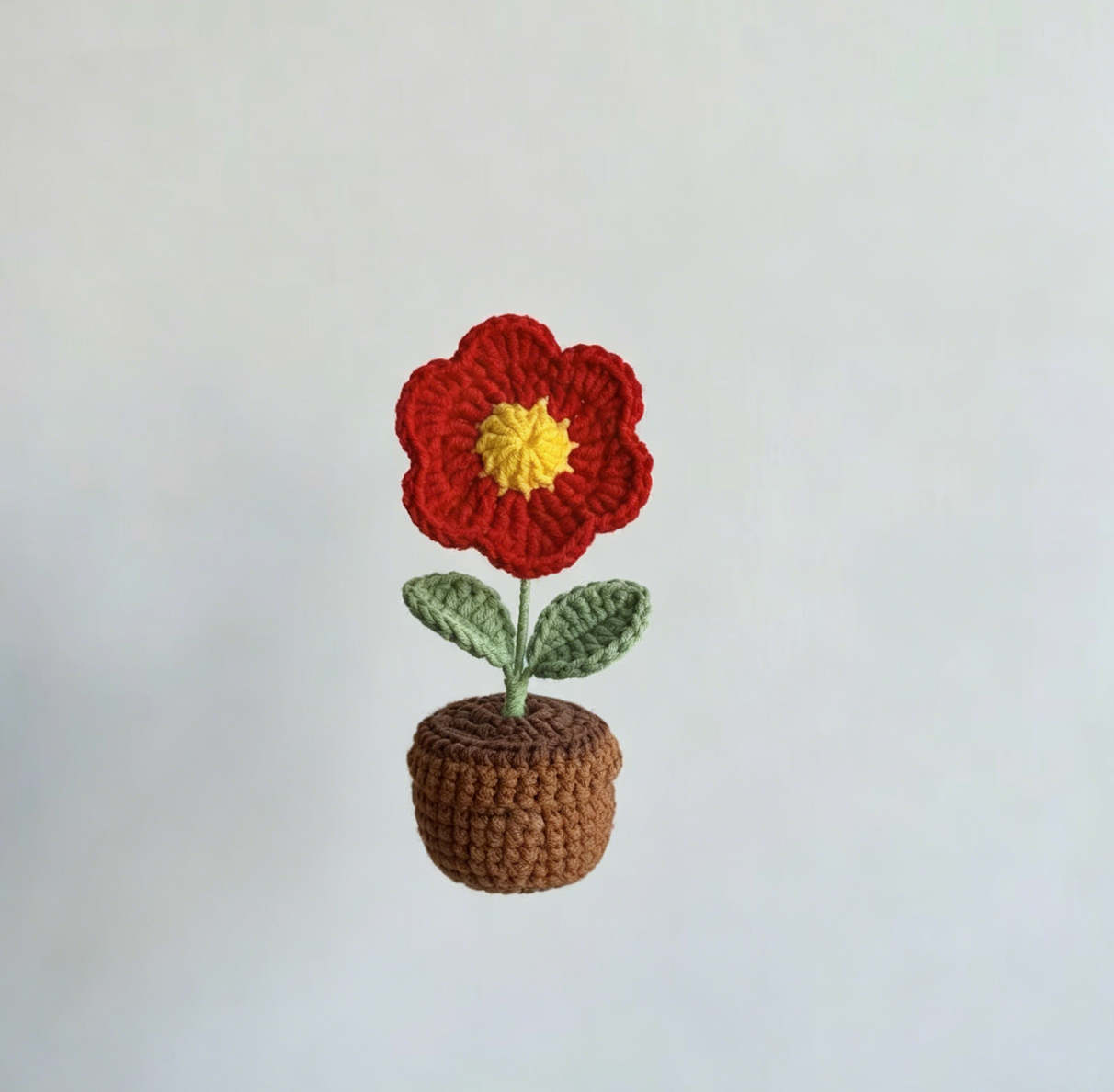 Cute handmade red flower crochet project from the Crochet Mini Flower Kit