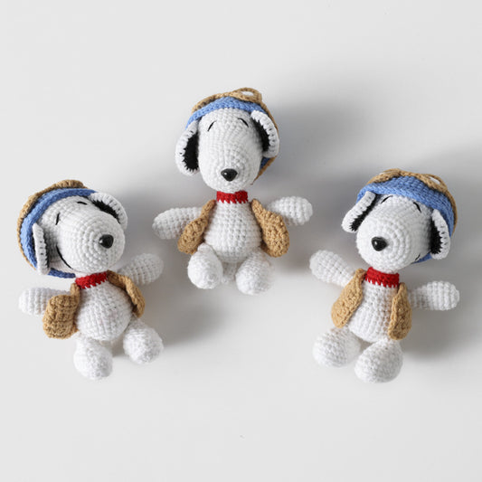 Close-up of crochet Snoopy plush showing facial features and stitching details