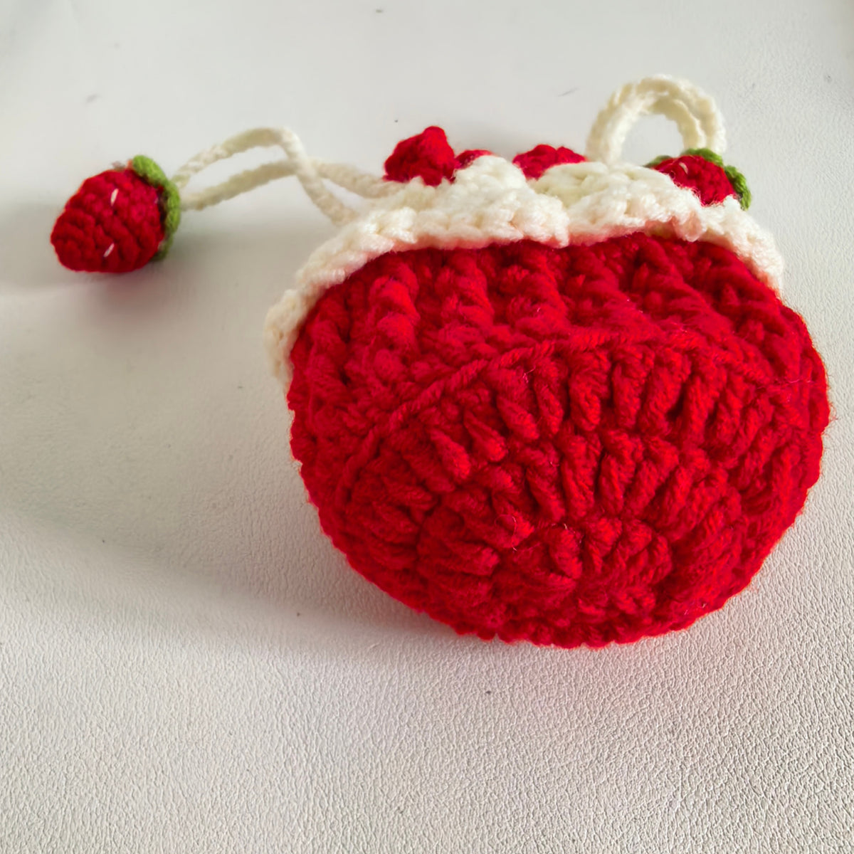 Bottom view of a mini crochet strawberry drawstring purse