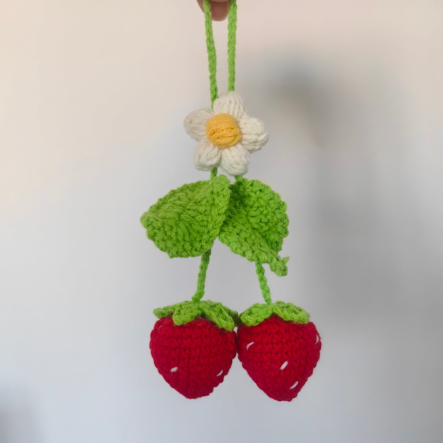 Close-up of handmade crochet strawberry with detailed stitches