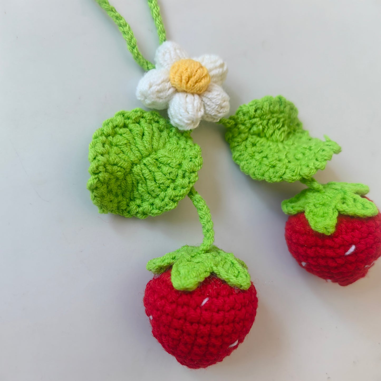 Cute crochet strawberry keychain made with the Crochet Strawberry Kit
