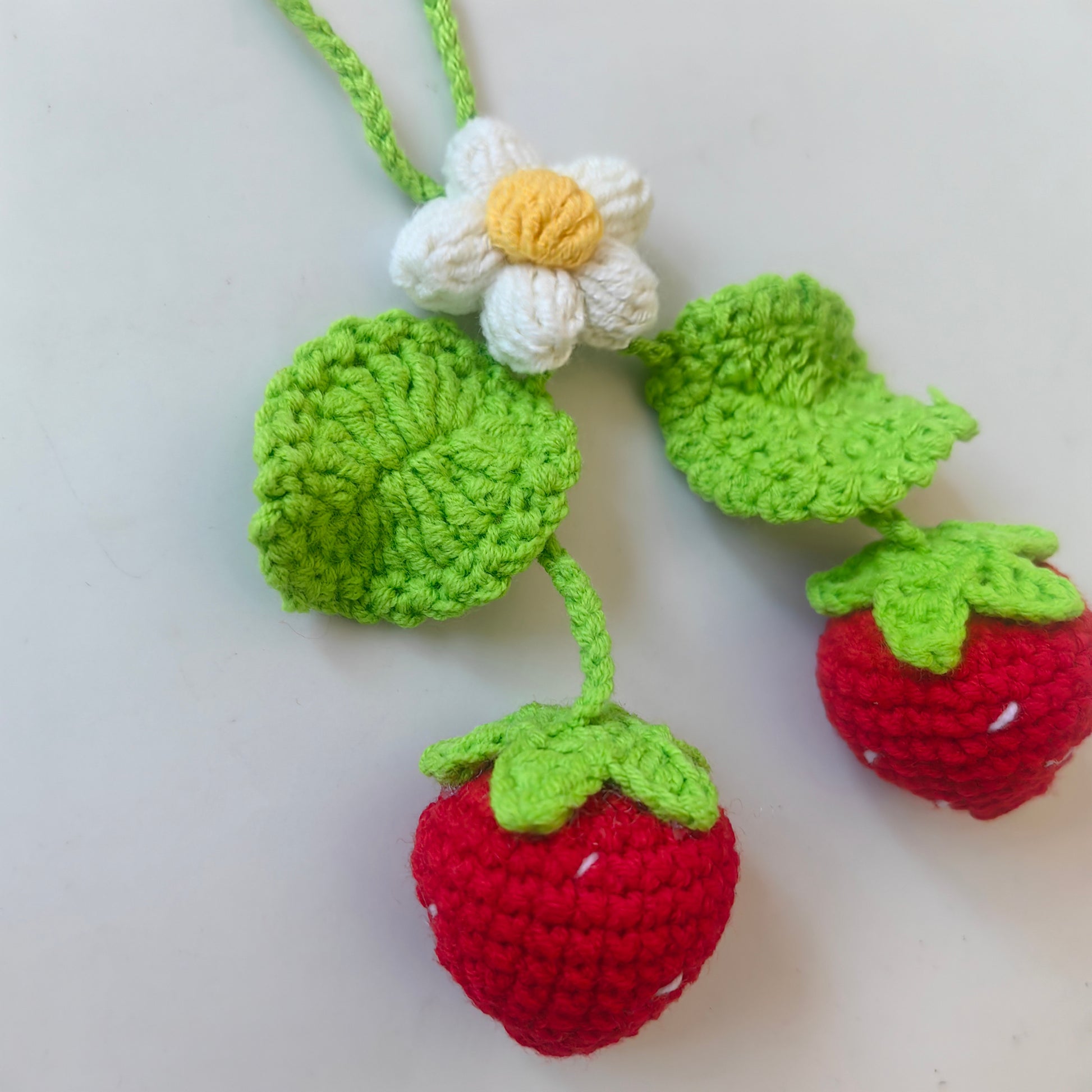 Cute crochet strawberry keychain made with the Crochet Strawberry Kit