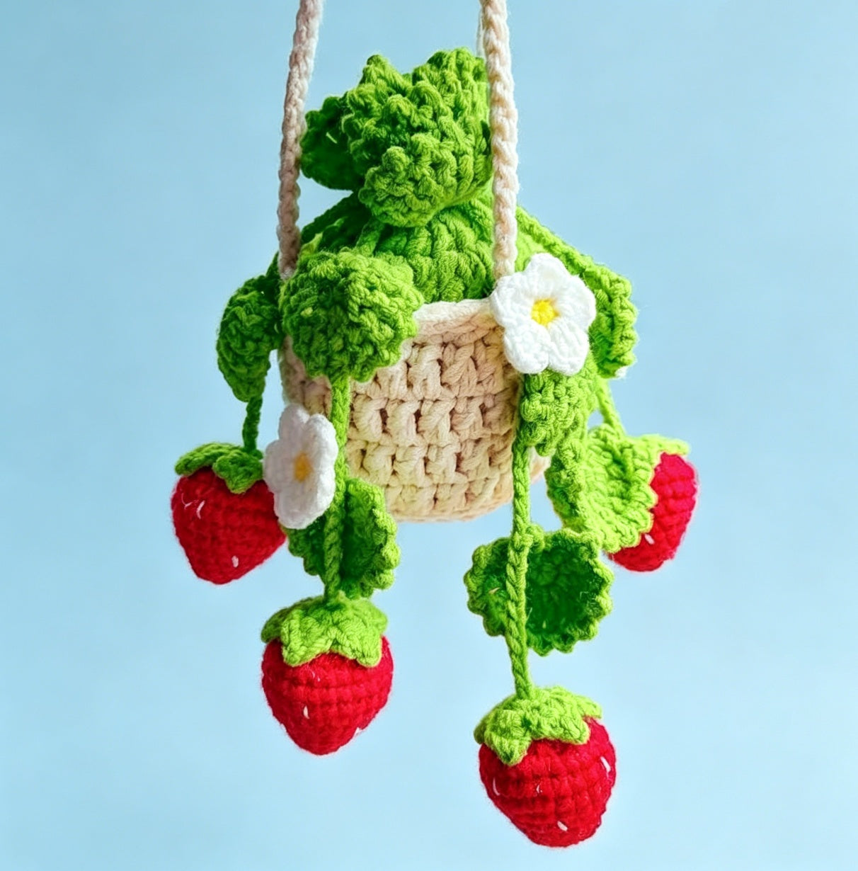 Close-up of the finished crochet strawberry with mini basket