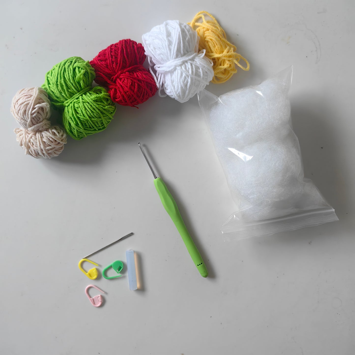 Complete crochet strawberry with mini basket kit including yarn, crochet hook, stuffing, accessories and video tutorial