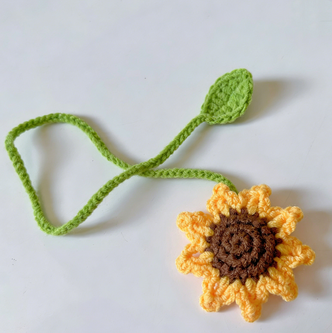 Handmade crochet sunflower bookmark with long stem and bright yellow petals