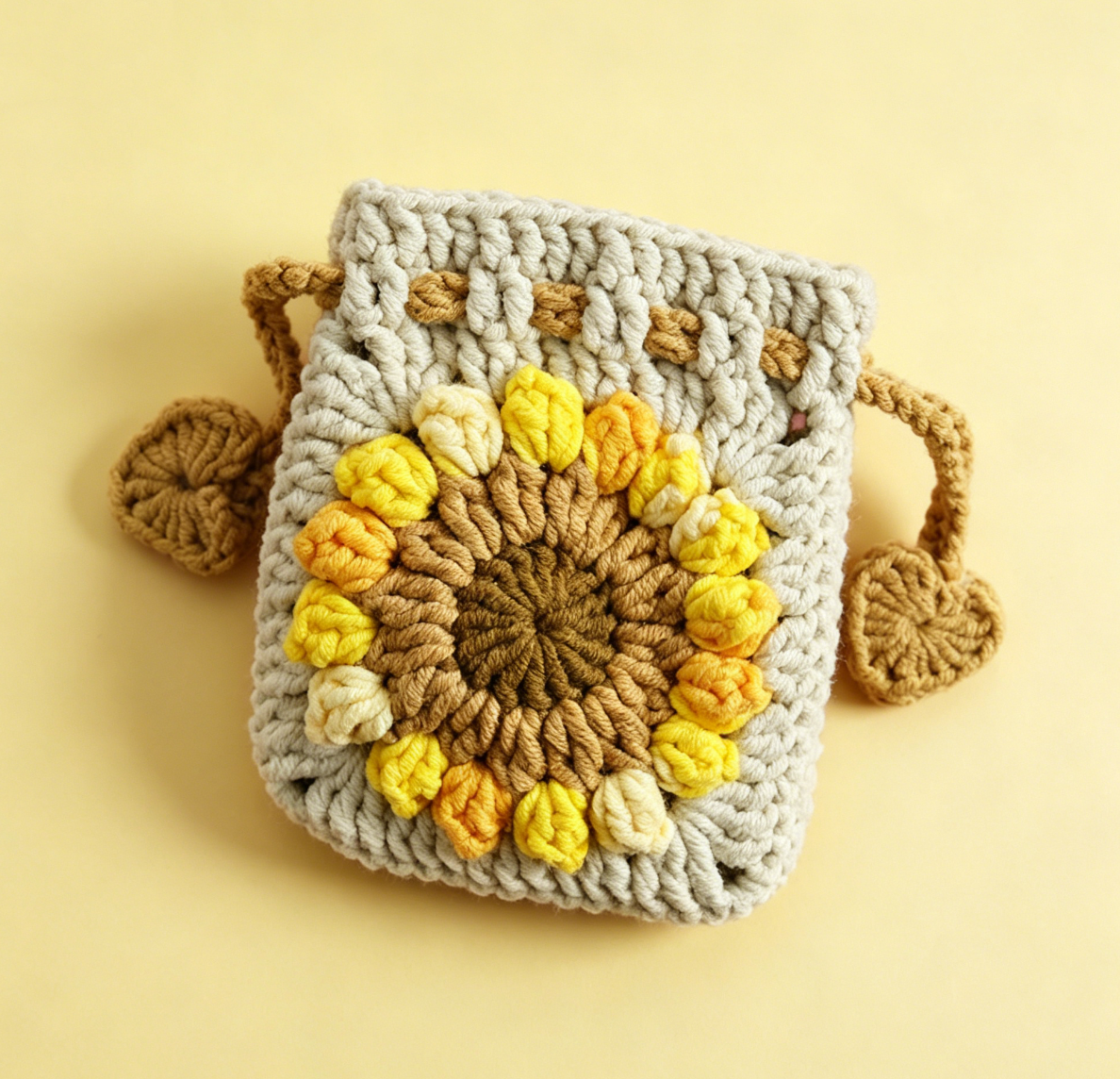 Beige crochet sunflower drawstring pouch handmade from DIY crochet kit