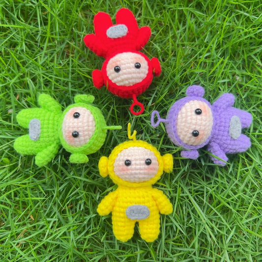 Crochet Teletubby kit displayed on grass from a top view