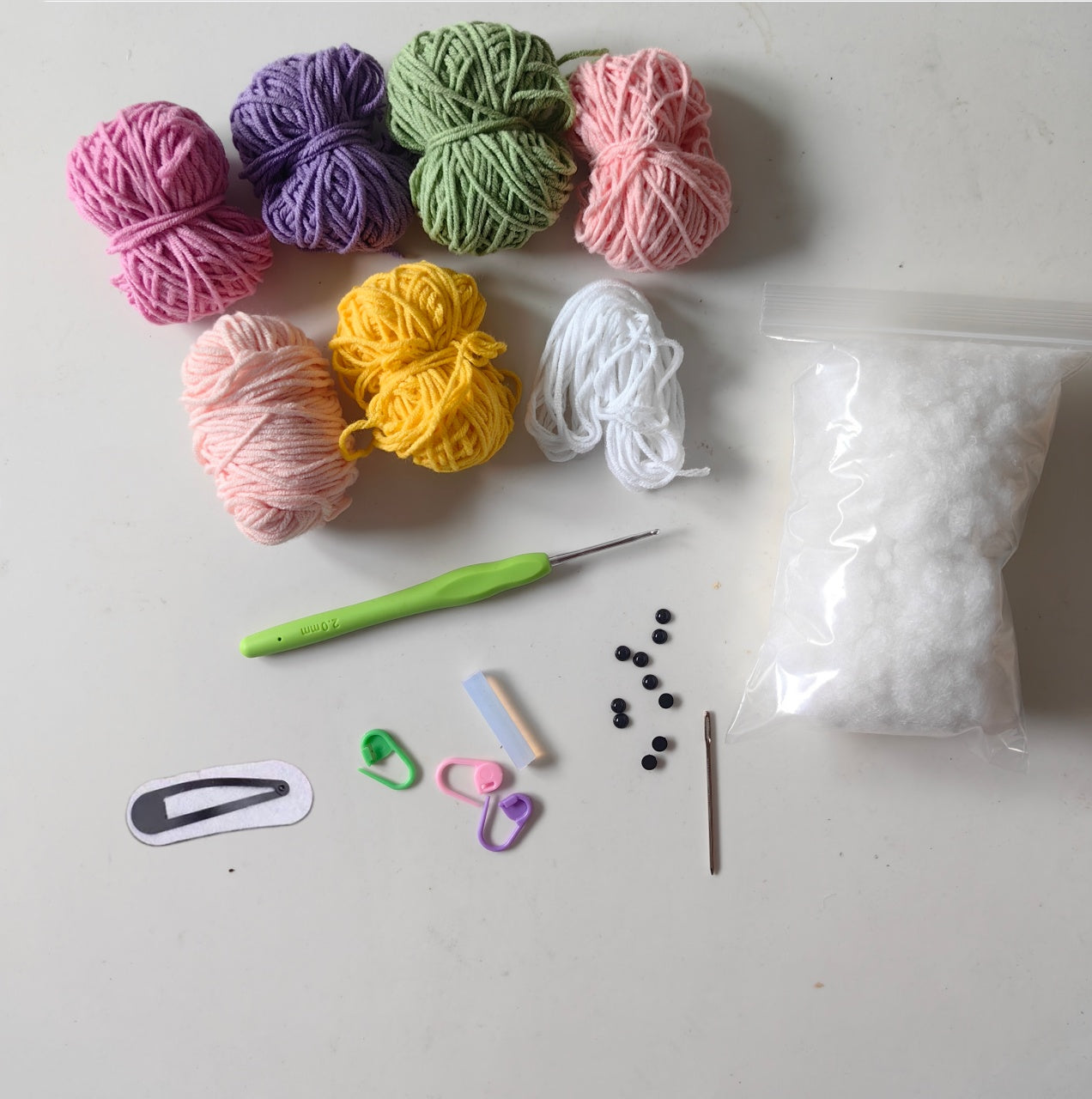 Complete crochet turtle hairpin kit materials including yarn, crochet tools, hair clips, stuffing, and accessories for DIY crafting.