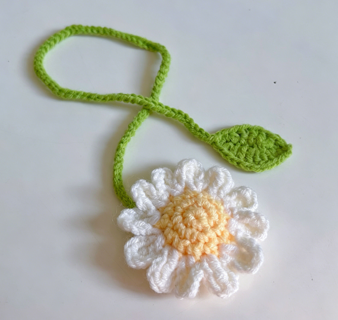 Cute crochet white daisy bookmark with detailed petals and green stem