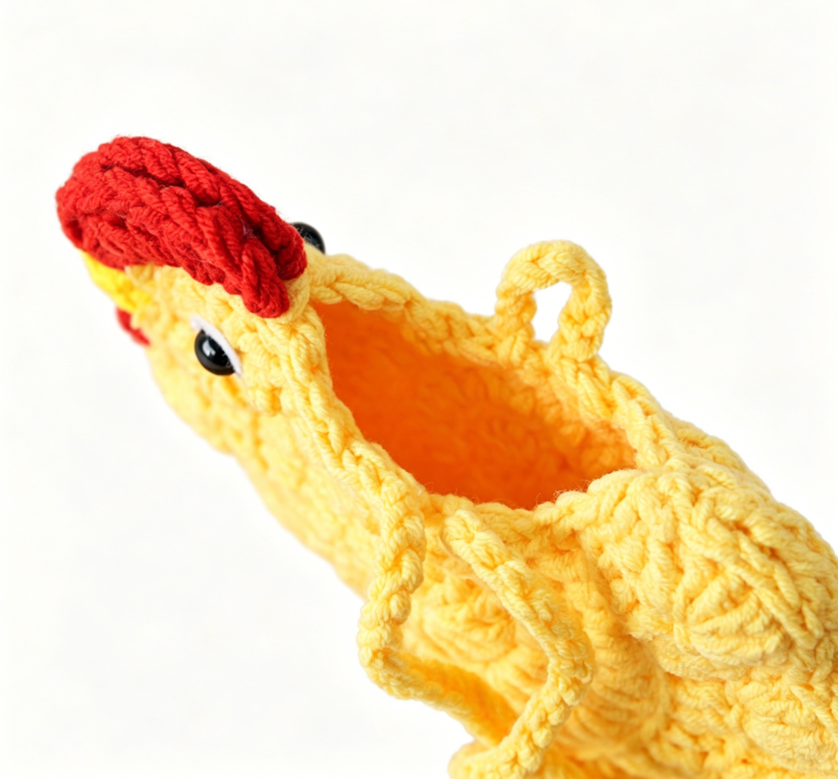 Close-up of the yellow crochet chick pouch featuring detailed stitching