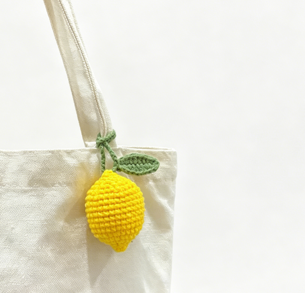 Close-up of a yellow crochet lemon plush with detailed stitching
