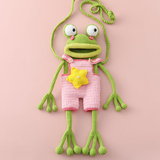 Frog crochet cross-body bag wearing a pink outfit