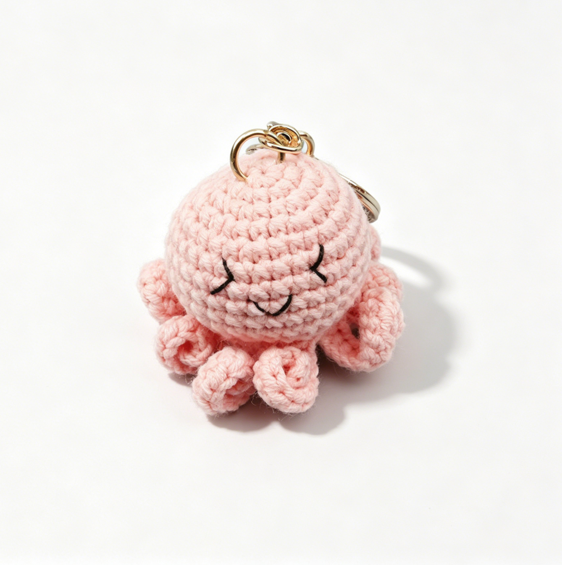 Adorable pink crochet octopus keychain made with the beginner crochet kit