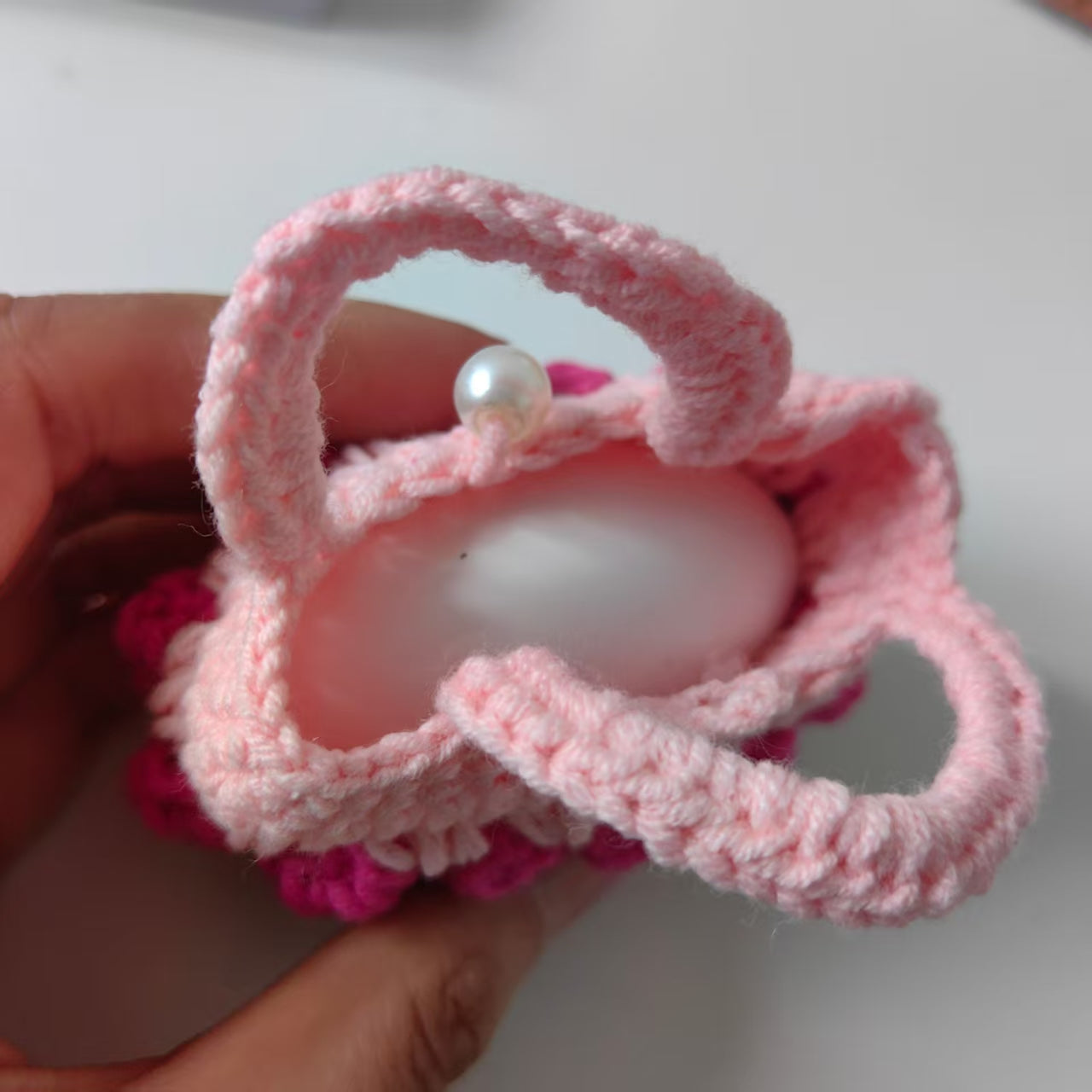 Pink crochet mini tulip pouch used as AirPods case