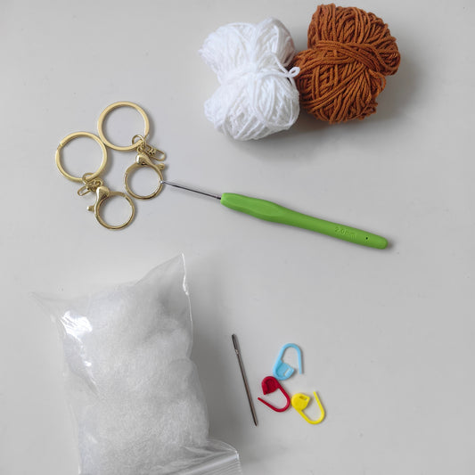 Complete crochet bear kit materials including yarn hook stuffing and accessories