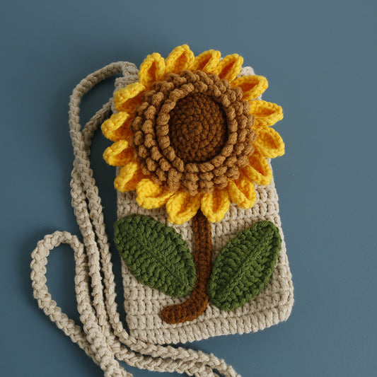 Front view of handmade sunflower crochet crossbody bag with leaf details